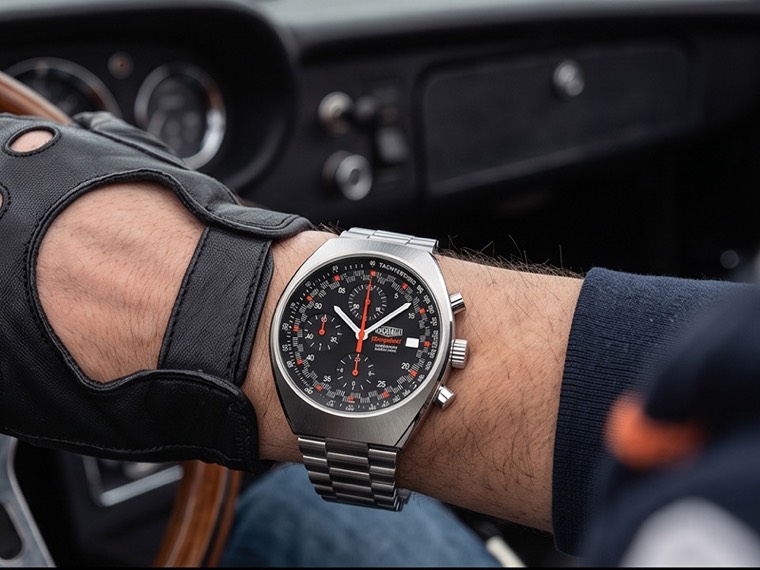 Monoplace au poignet d'un conducteur ganté, au volant d'une voiture ancienne.